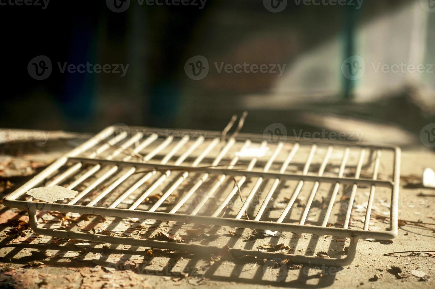 An old white refrigerator shelf in an abandoned and devastated kitchen photo