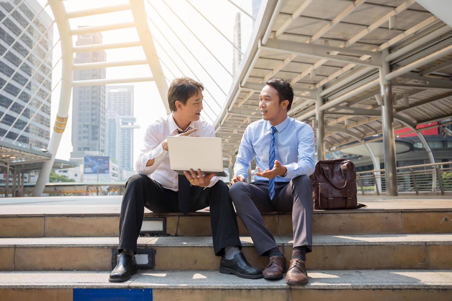 Two businessmen are working with smart phone and notebook for business concept. photo