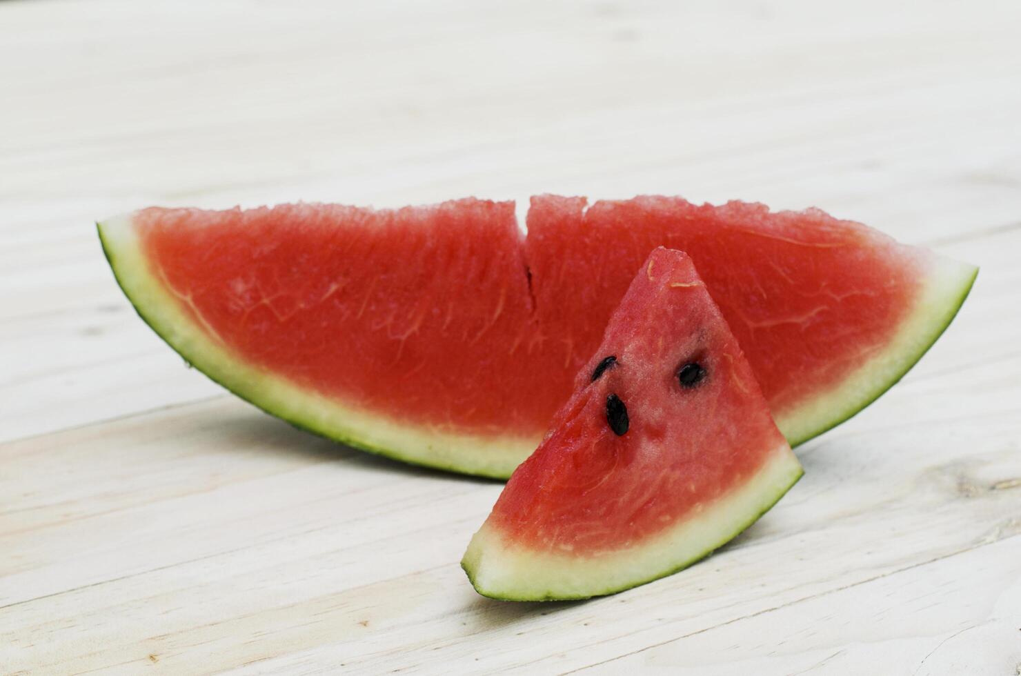 Close up of Sliced watermelon on wooden table backgrounds photo