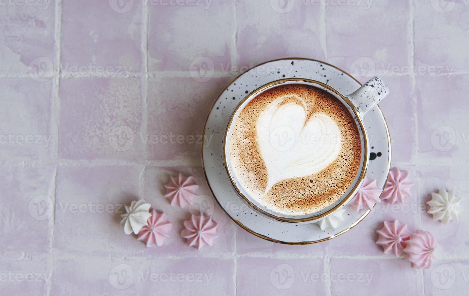 Cup with coffee and small meringues photo