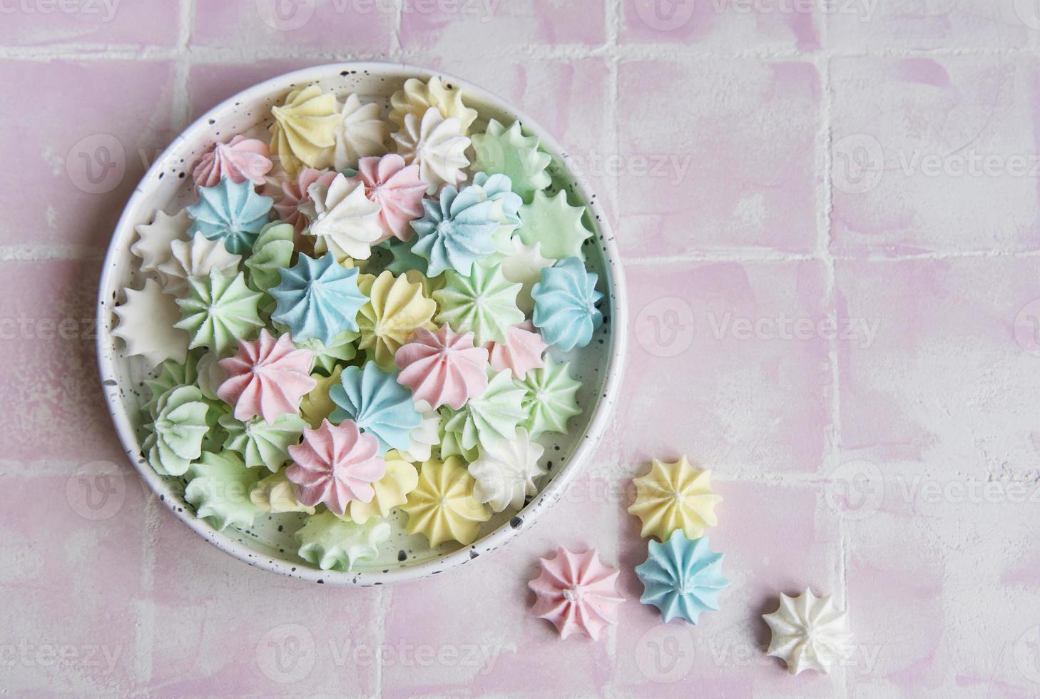 Small colorful meringues in the ceramic  bowl photo