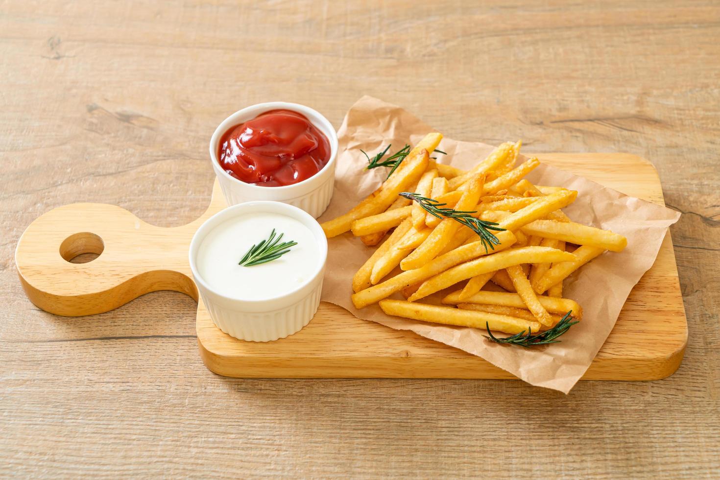 French fries with sour cream and ketchup photo