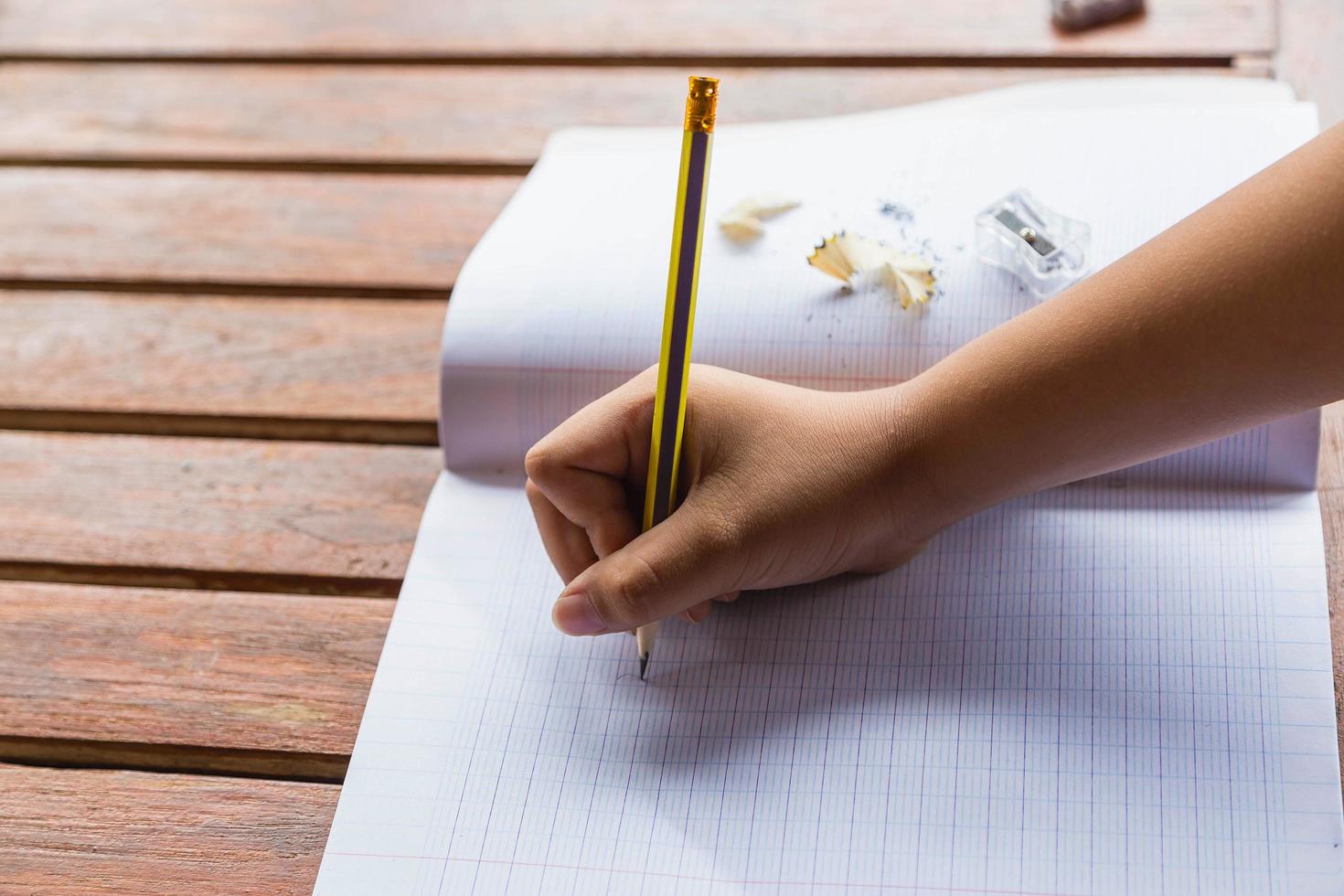 Students writing on the desk photo