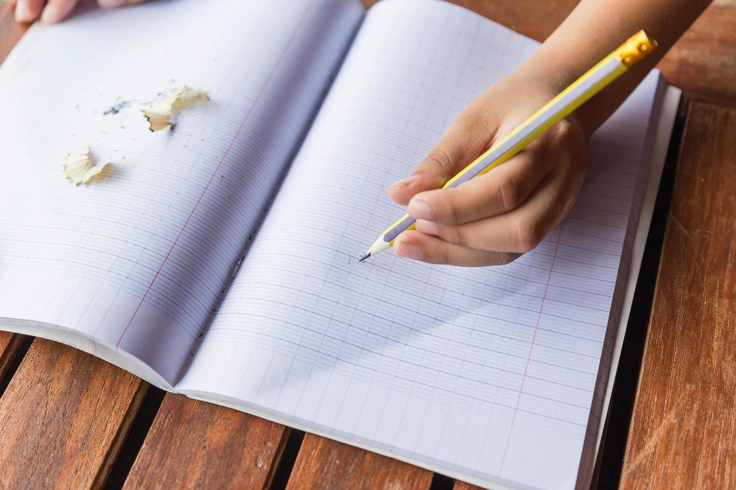 Students writing on the desk photo