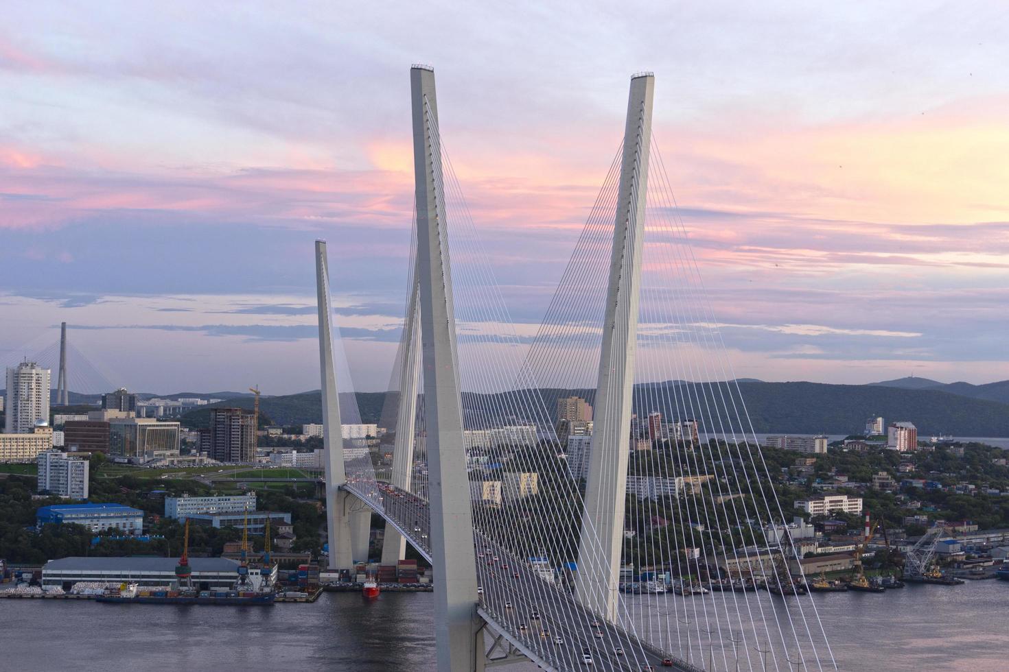 paisaje urbano con vistas al puente dorado al atardecer vladivostok rusia foto