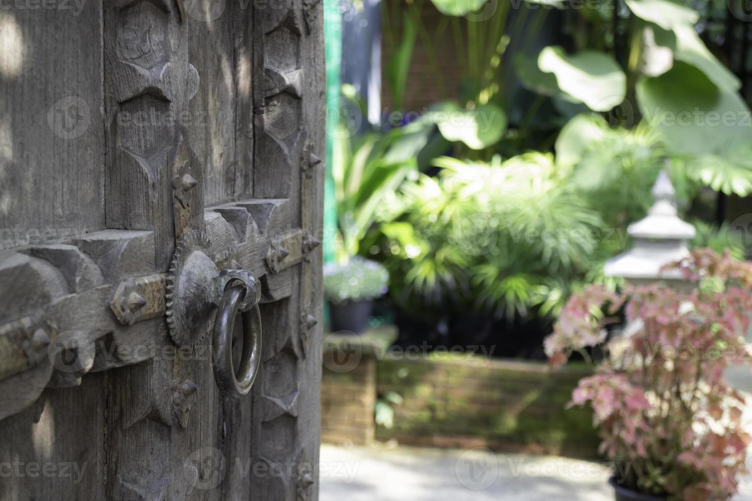 Old open wooden door with carved pattern photo