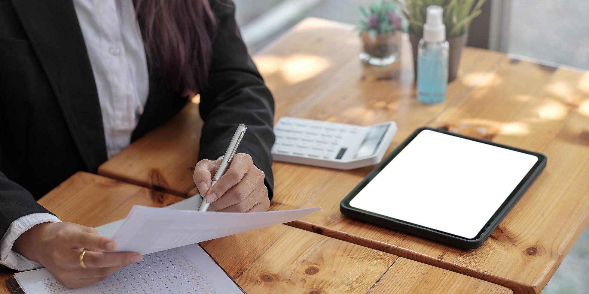 Close up of bookkeeper or financial inspector hands making report, calculating or checking balance. Home finances, investment, economy, saving money or insurance concept photo