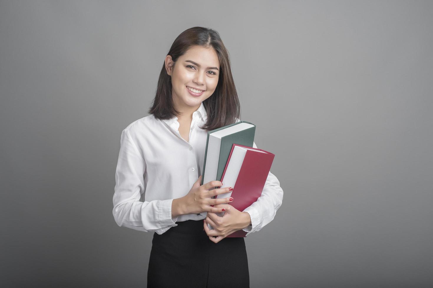 Business woman in white shirt on grey background photo