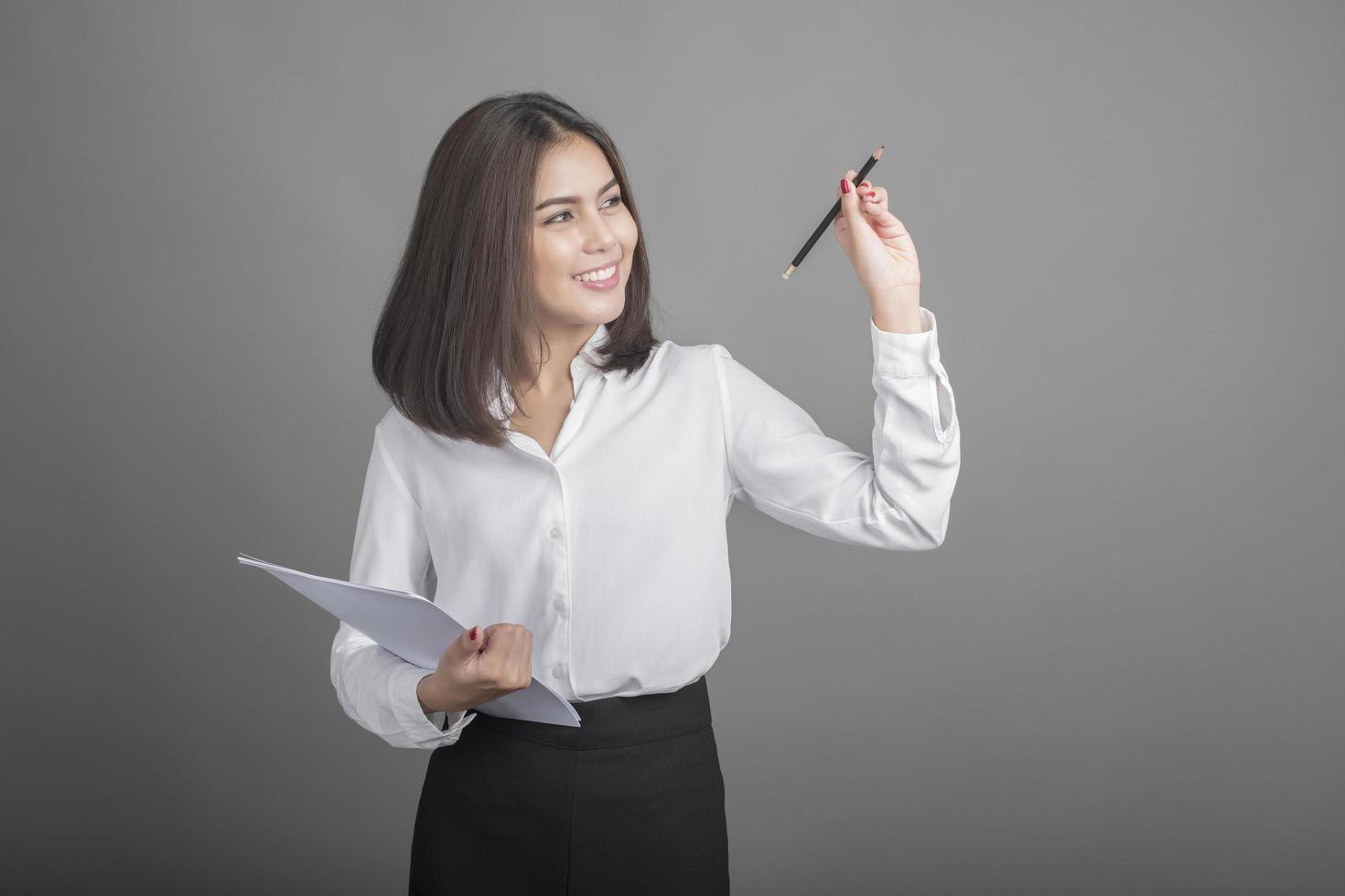 Business woman in white shirt on grey background photo