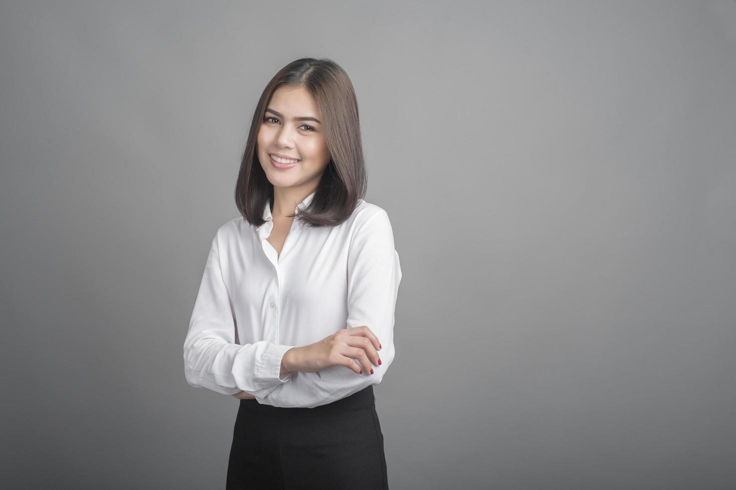 Business woman in white shirt on grey background photo