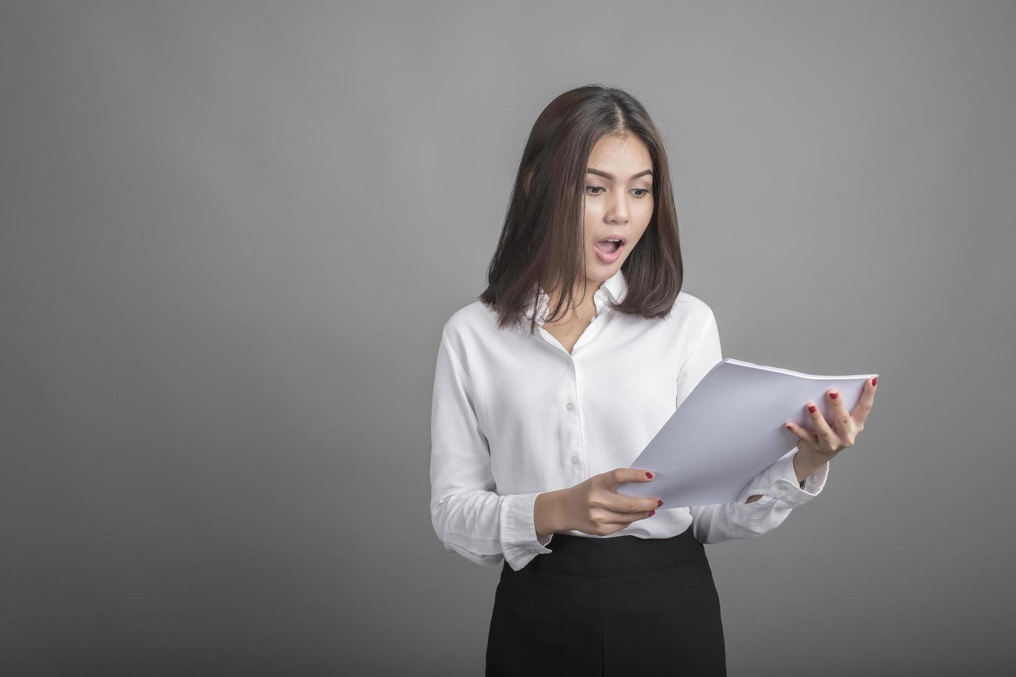 Business woman in white shirt on grey background photo