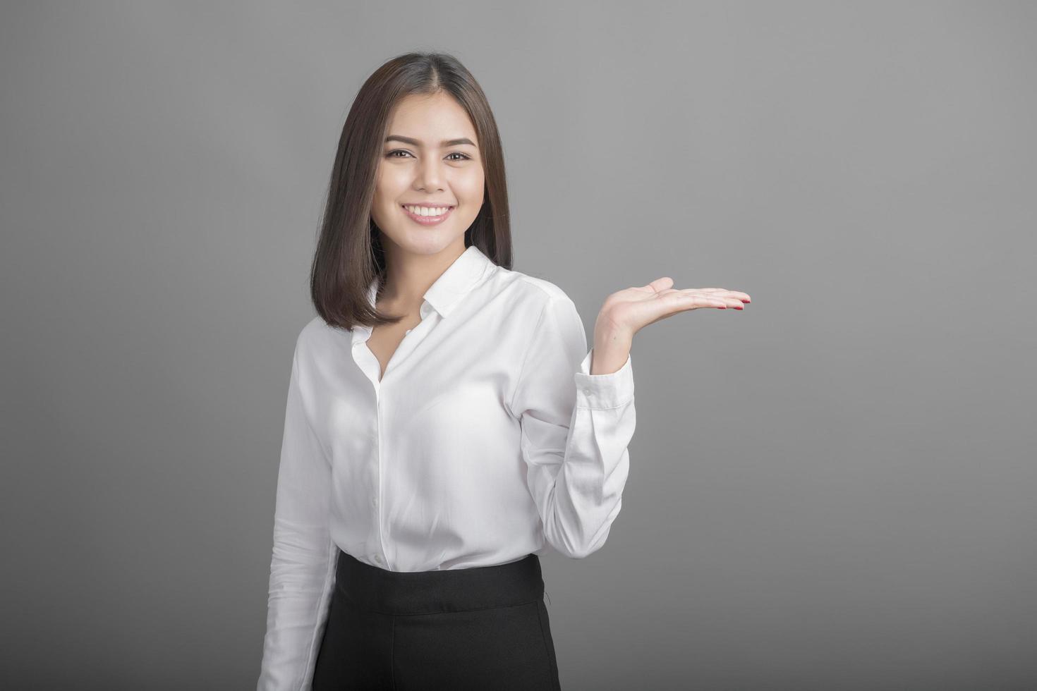 Business woman in white shirt on grey background photo