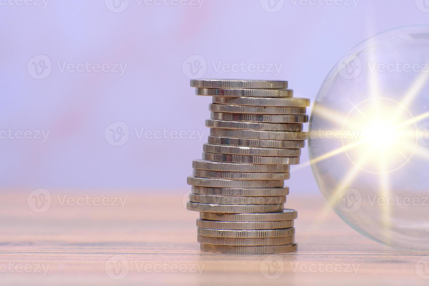 saving money concept and stacking coins on table background photo