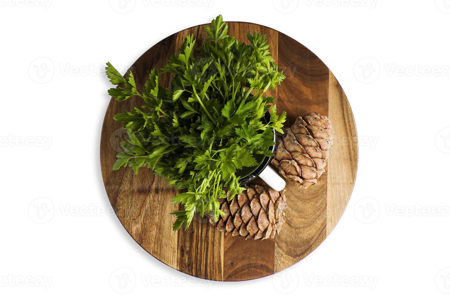 Green parsley leaf on a wooden cutting board, isolate photo