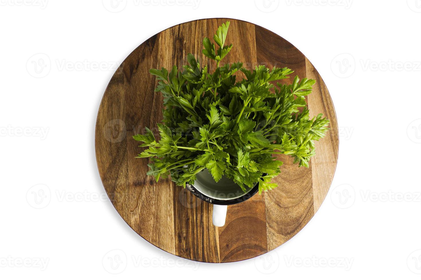 Green parsley leaf on a wooden cutting board, isolate photo