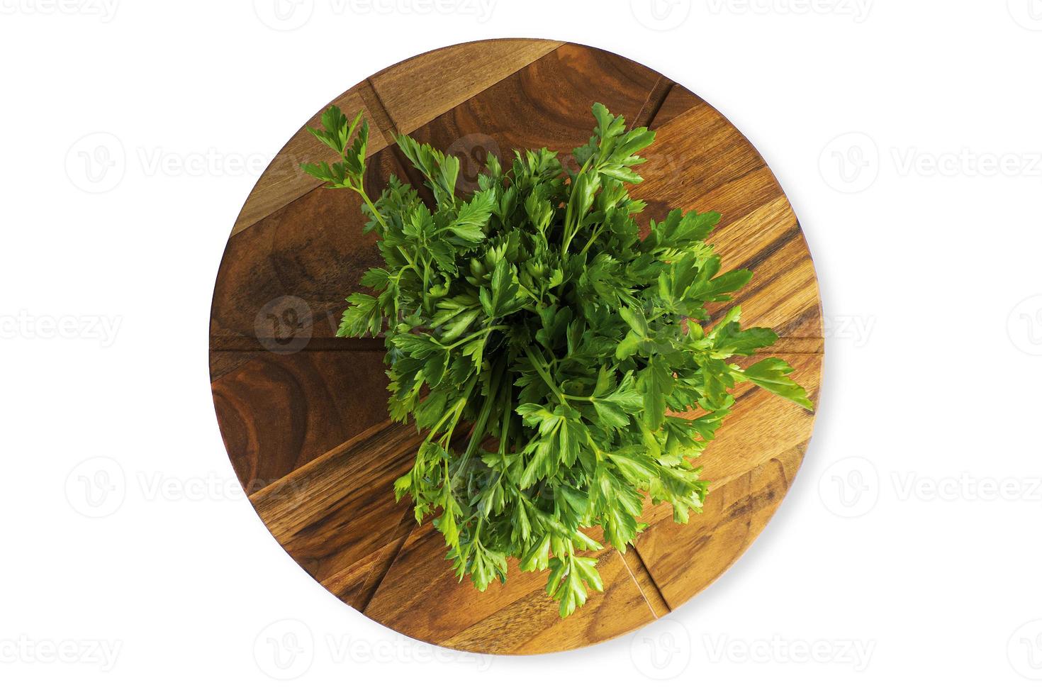 Green parsley leaf on a wooden cutting board, isolate photo