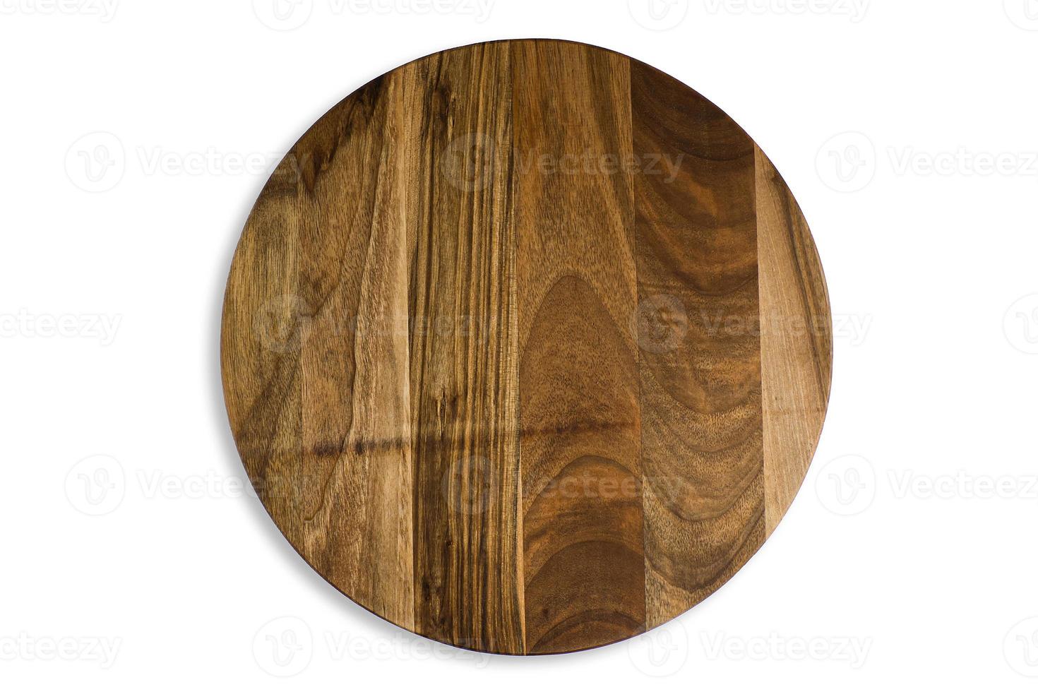 Old round wooden cutting board isolated on white background. Closeup of textured rustic platter for cutting pizza, bread or meals serving, top view photo