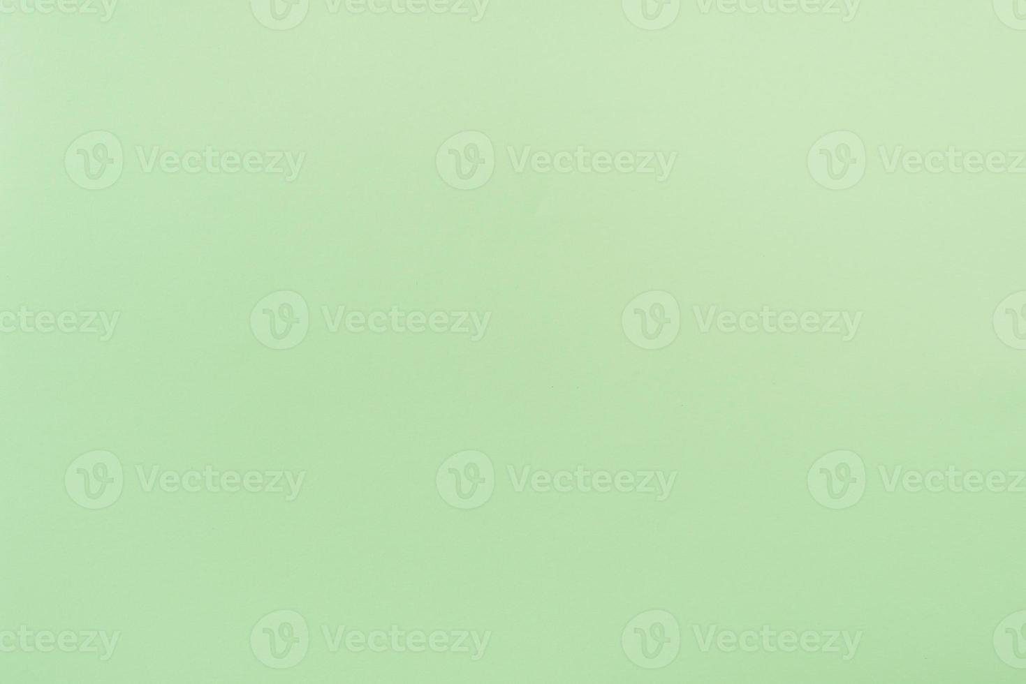Green paper with soft texture. Simple background. photo