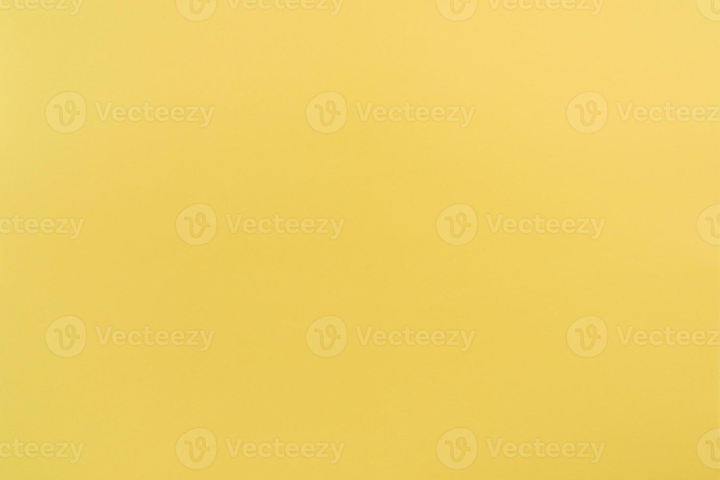 Yellow paper with soft texture. Simple background. photo