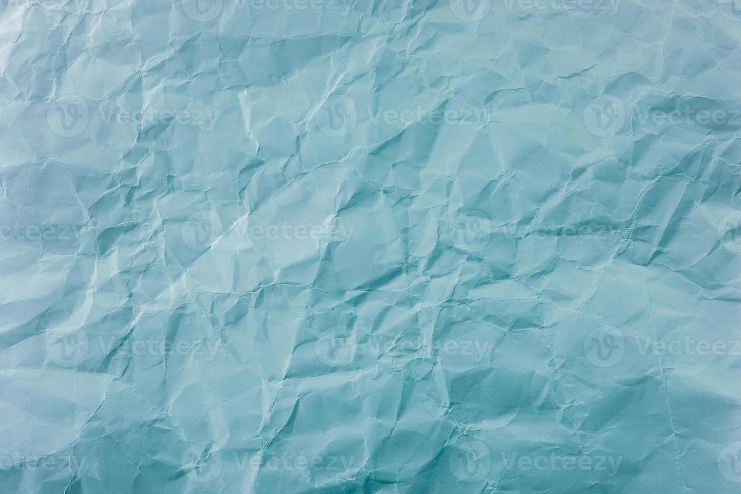 Crumpled Blue paper with soft texture. Simple background. photo