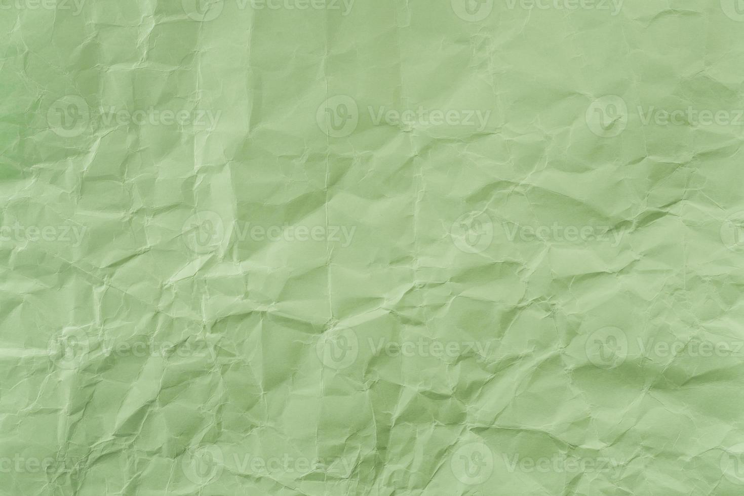 Crumpled Green paper with soft texture. Simple background. photo