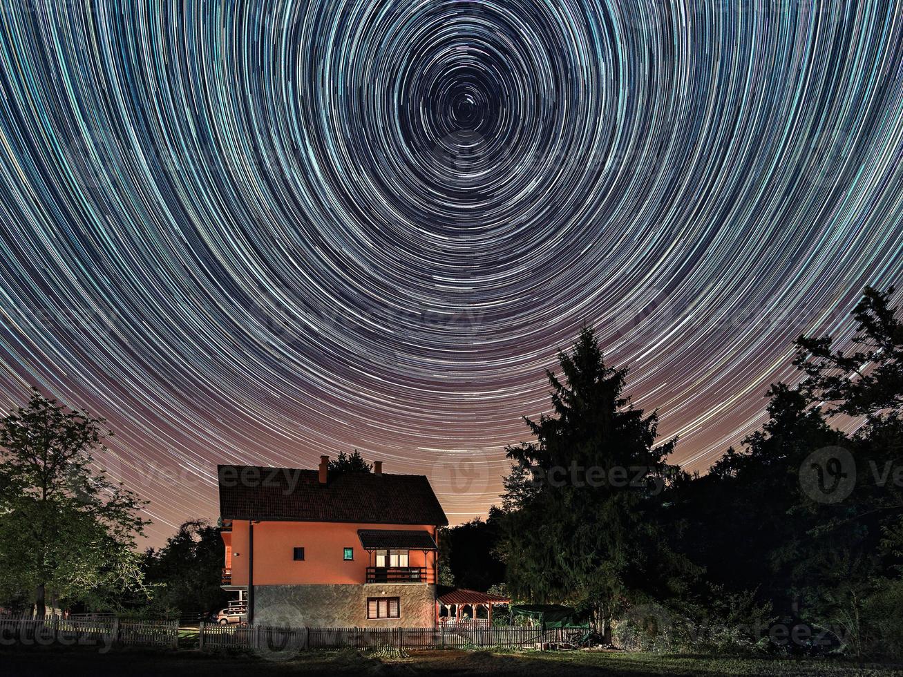 Star trails above the house. Residential building and the star trails on the sky. The night sky is astronomically accurate. photo