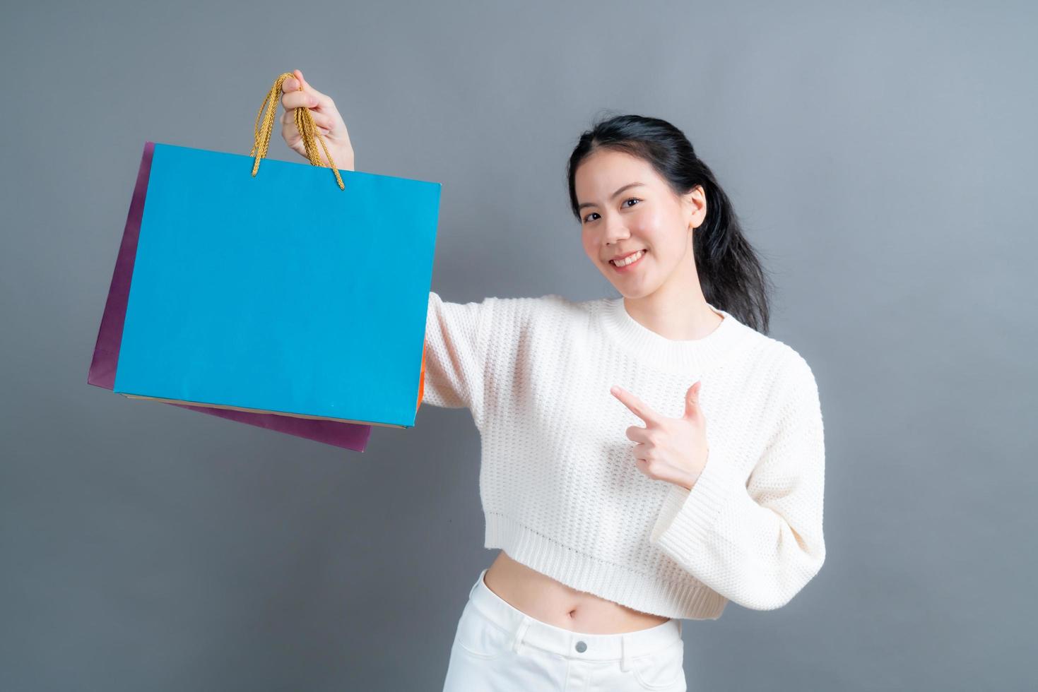 Asian woman holding shopping bags photo