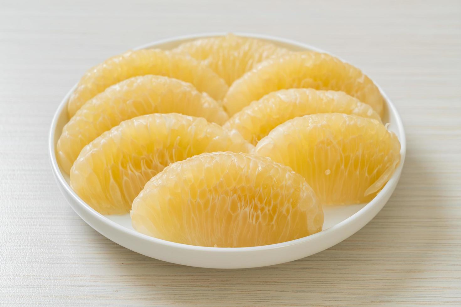 Fresh peeled pomelo grapefruit or shaddock photo