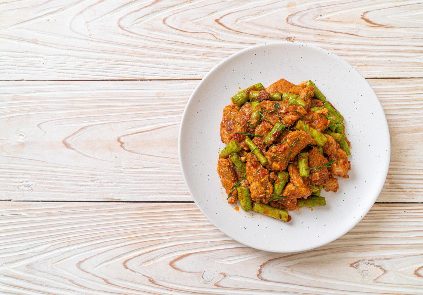 Stir fried pork and red curry paste with sting bean photo