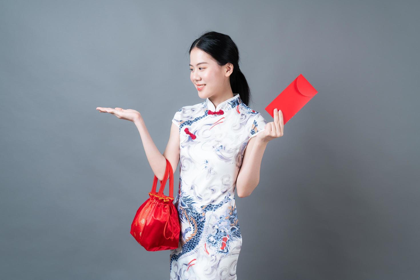 Asian woman wear Chinese traditional dress with red envelope or red packet photo