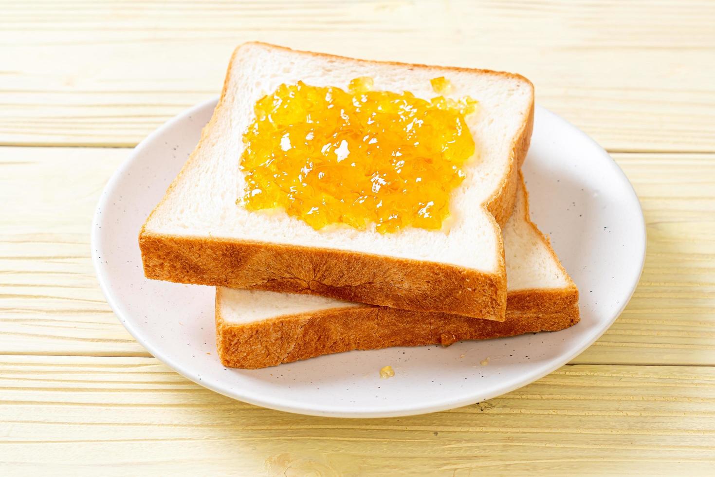 Slices of bread with orange jam photo