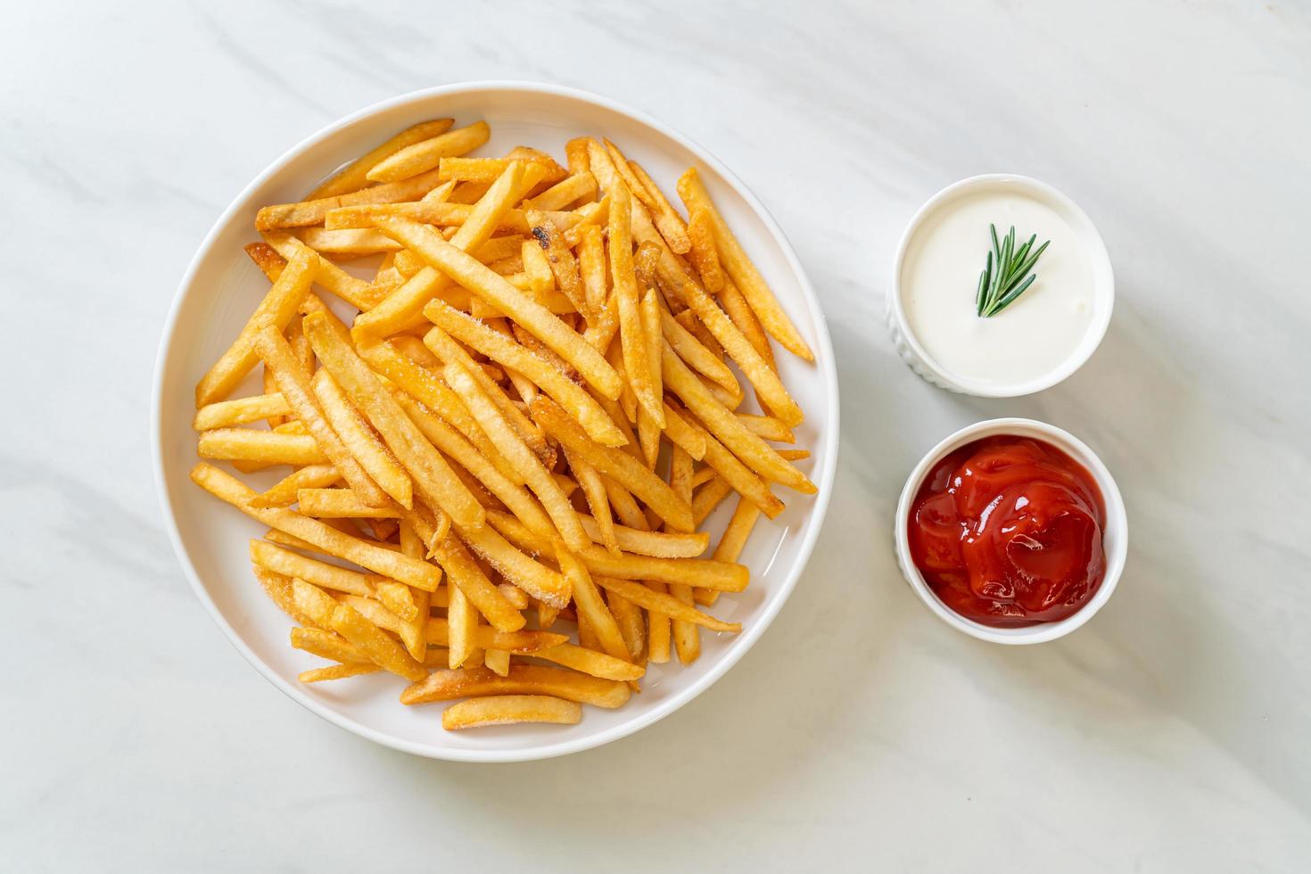 French fries with sour cream and ketchup photo