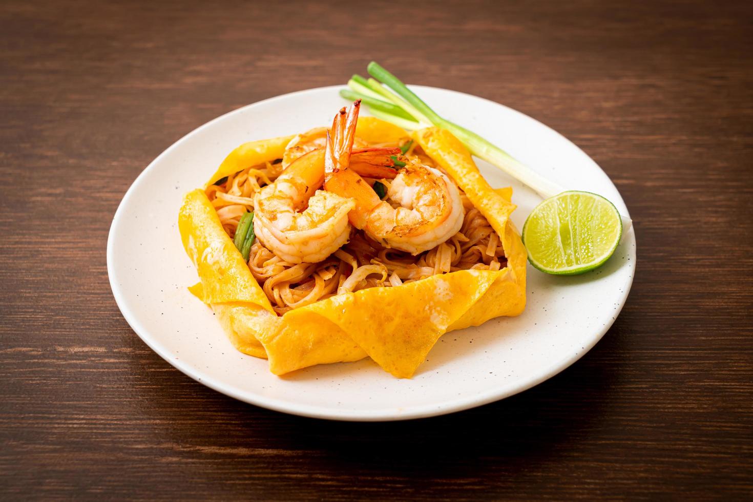 Thai stir fried noodles with shrimps and egg wrap or Pad Thai photo