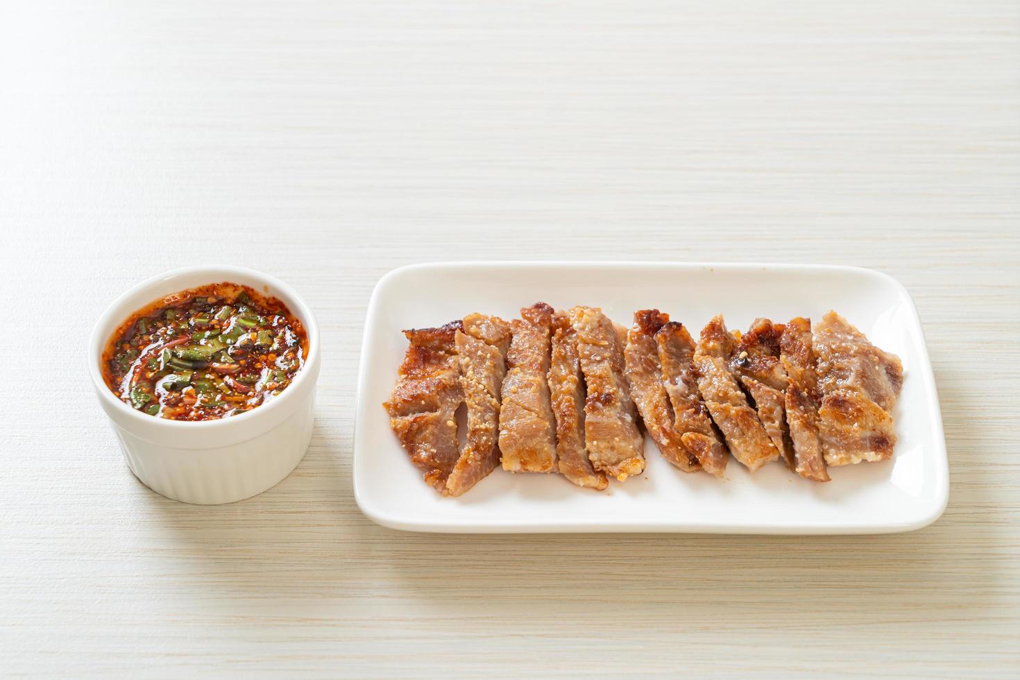 Grilled pork neck or charcoal-boiled pork neck with Thai spicy dipping sauce photo