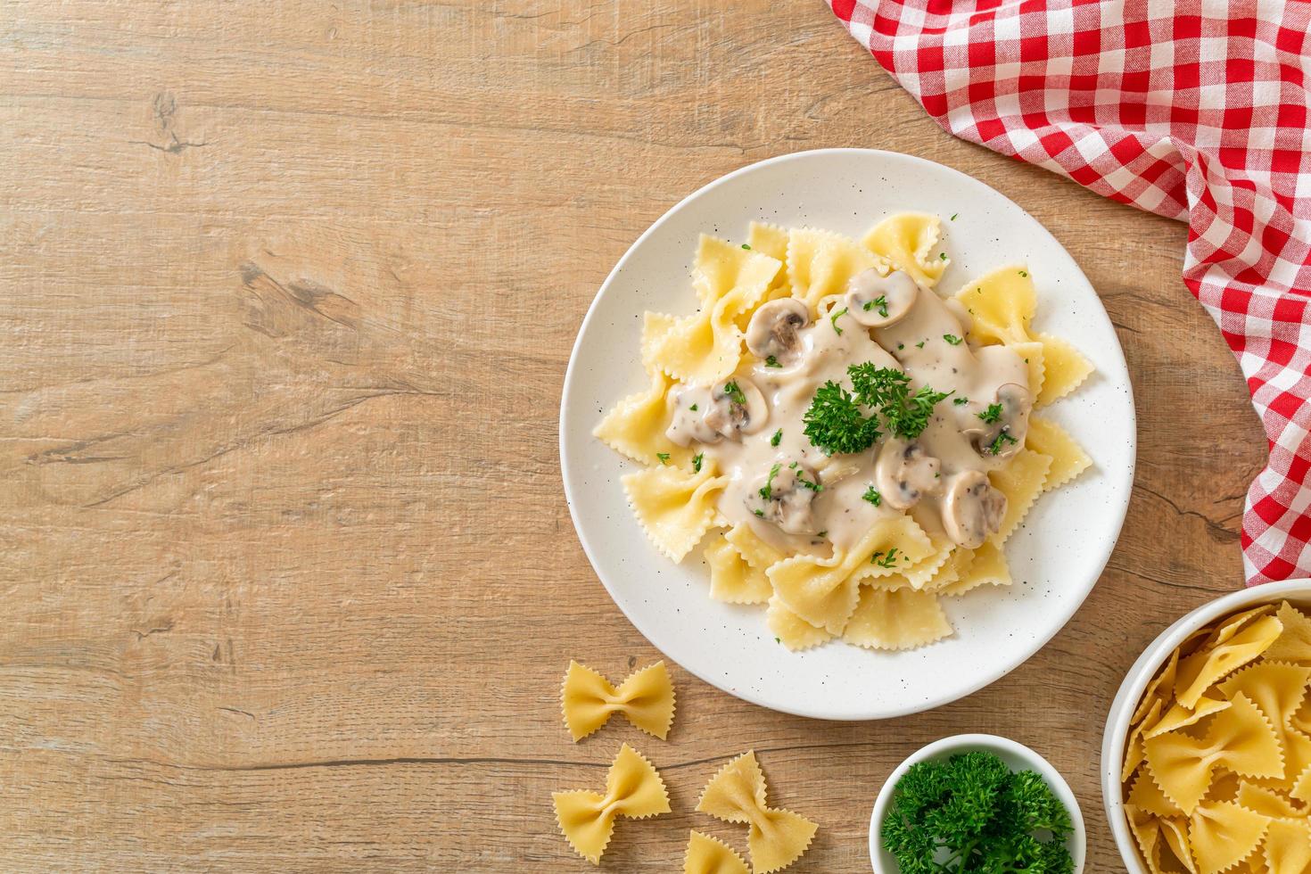 Farfalle pasta with mushroom white cream sauce - Italian food style photo