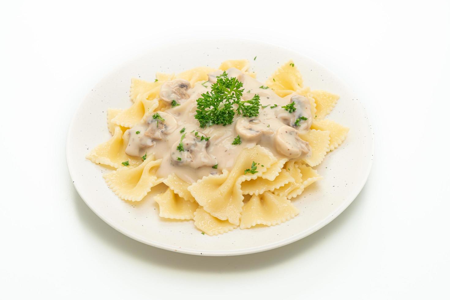 Farfalle pasta with mushroom white cream sauce - Italian food style photo