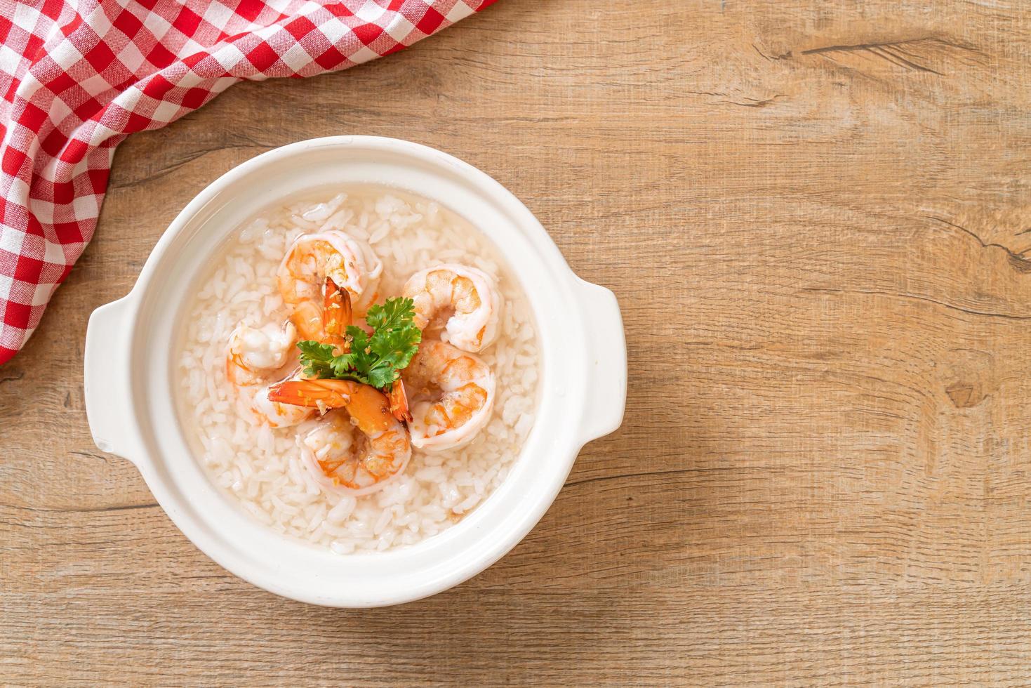 Porridge or boiled rice soup with shrimps bowl photo