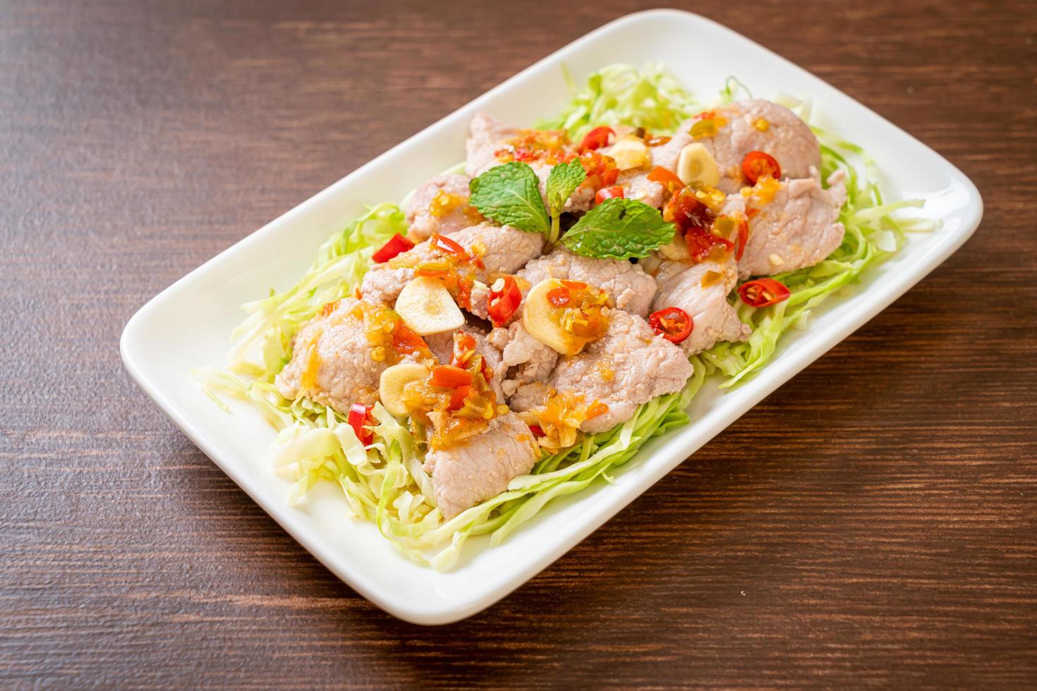 Spicy pork salad or boiled pork with lime garlic and chili sauce photo