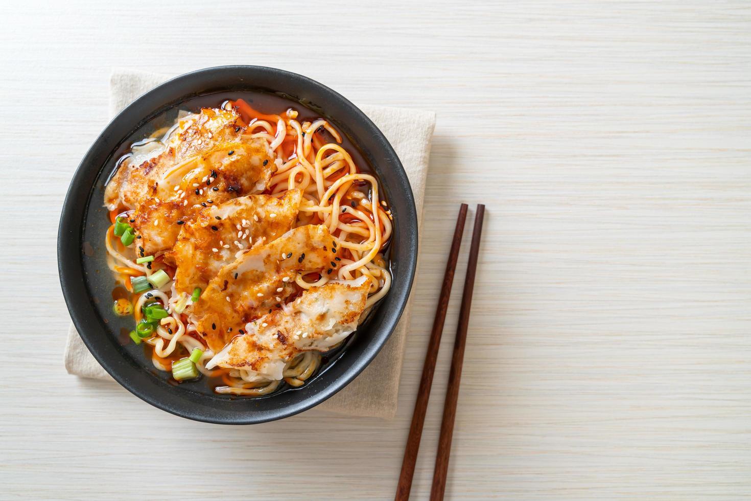 Ramen noodles with gyoza or pork dumplings - Asian food style photo