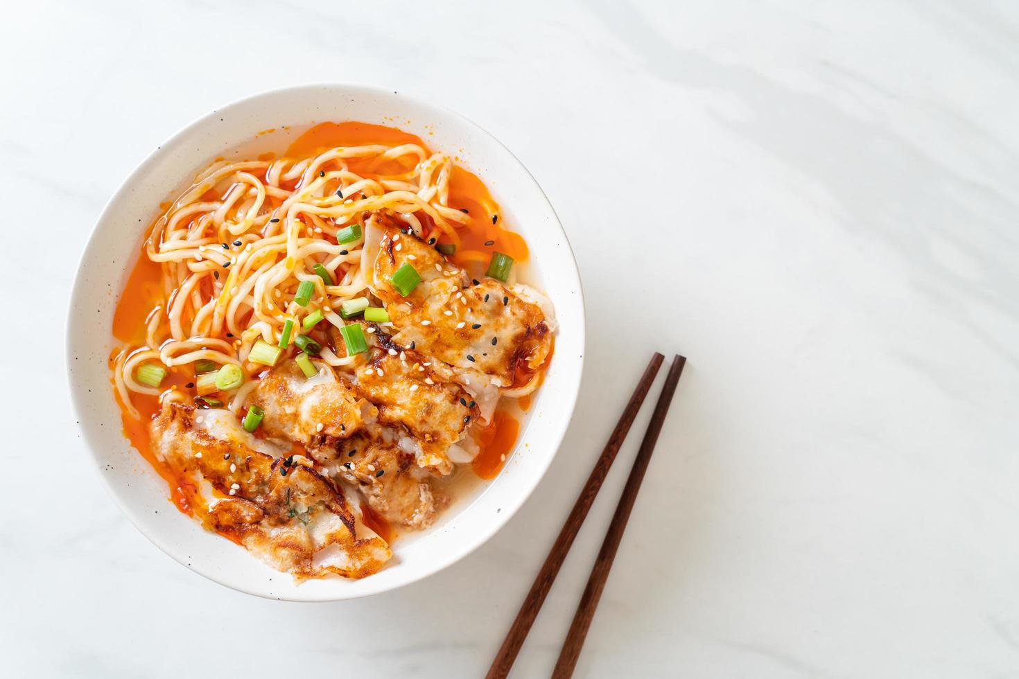 Ramen noodles with gyoza or pork dumplings - Asian food style photo