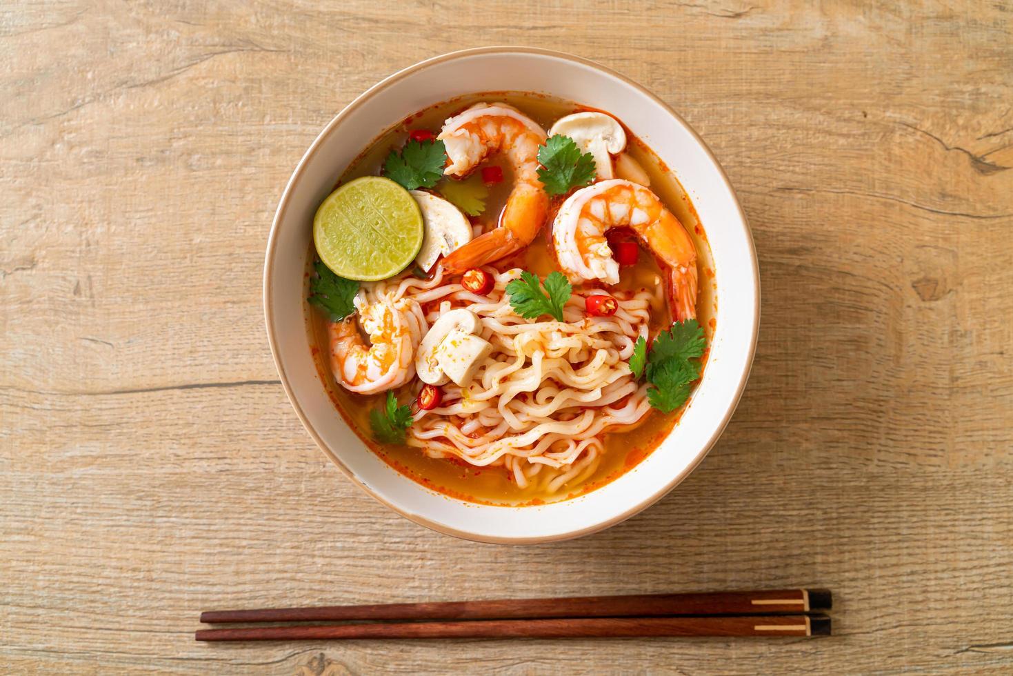 Instant noodles ramen in spicy soup with shrimps - Tom Yum Kung - Asian food style photo