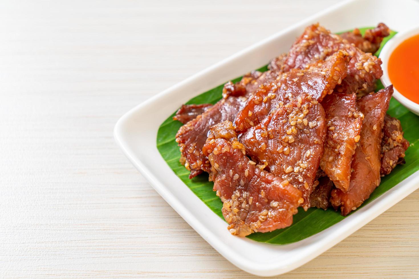 Sun-dried pork with sauce on a plate photo