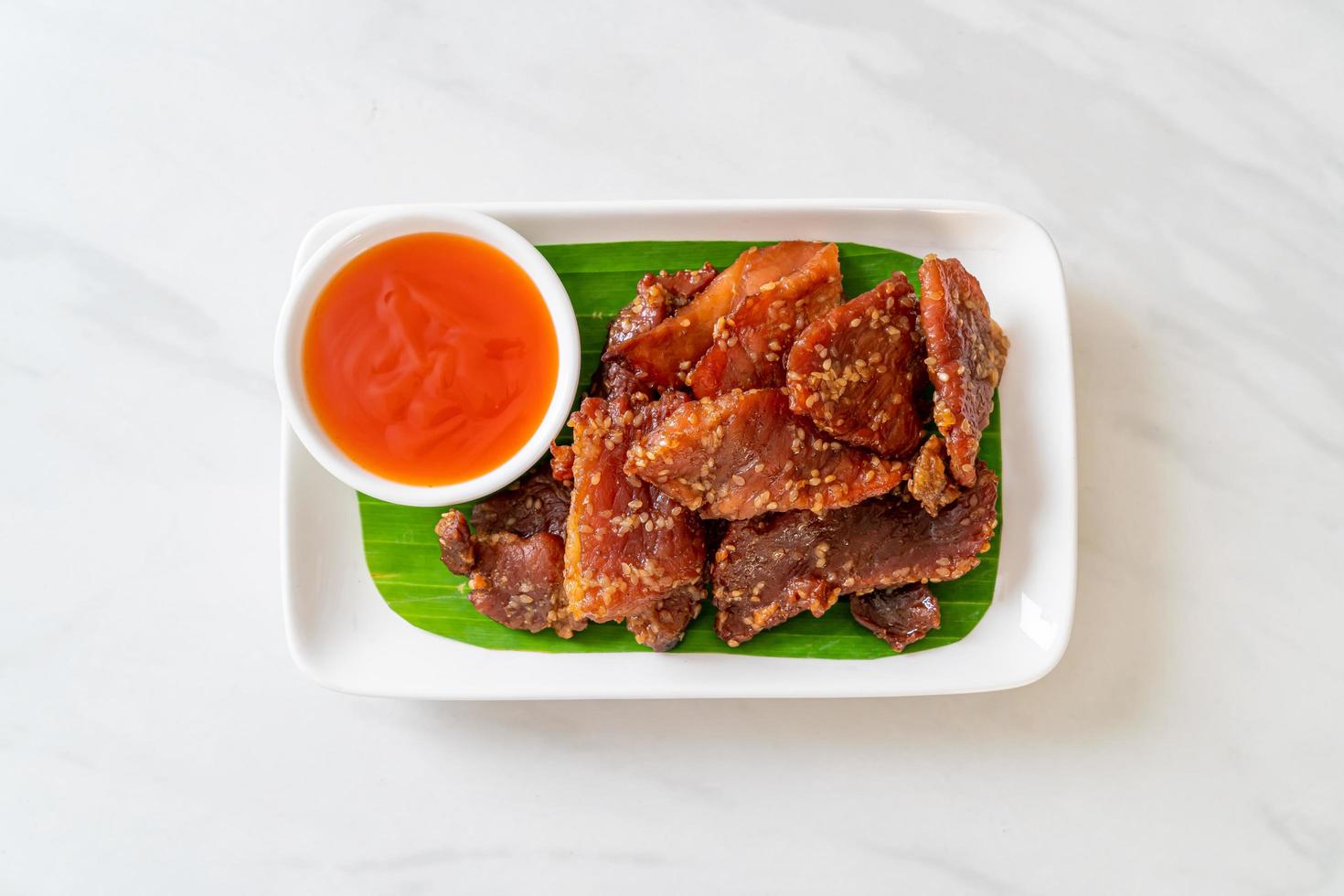 Sun-dried pork with sauce on a plate photo