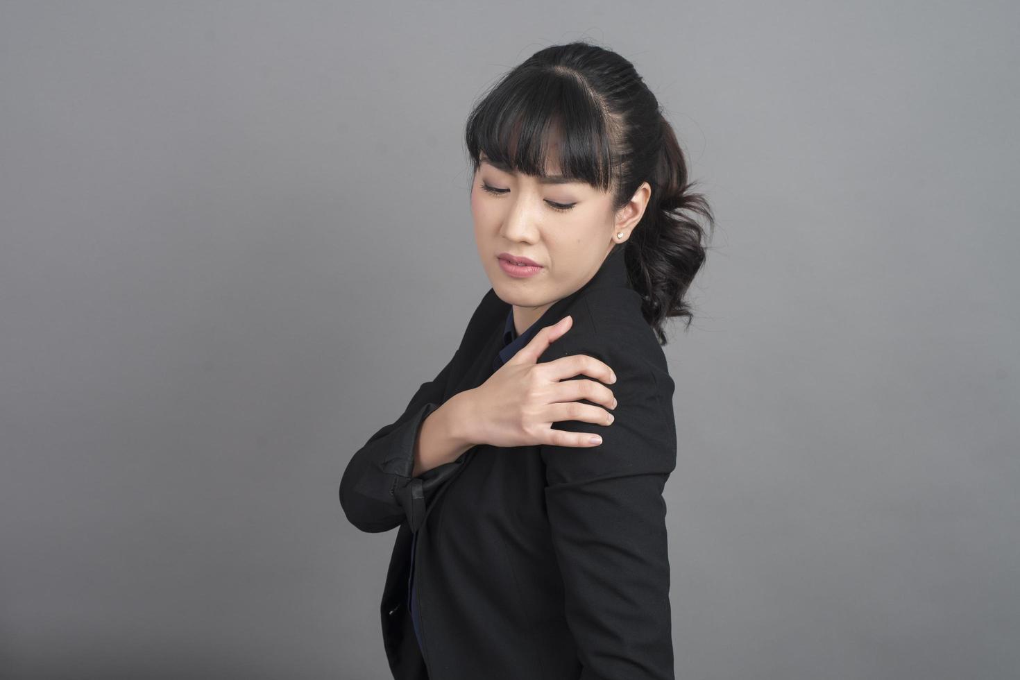 Business woman in blazer with shoulder pain photo