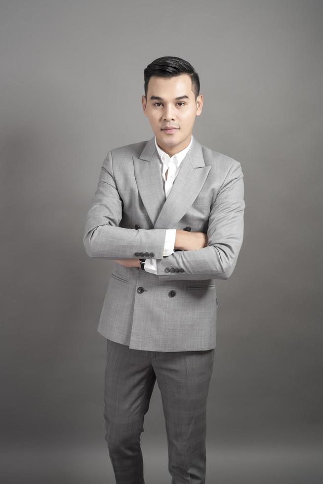 Businessman is smart portrait in studio grey background photo