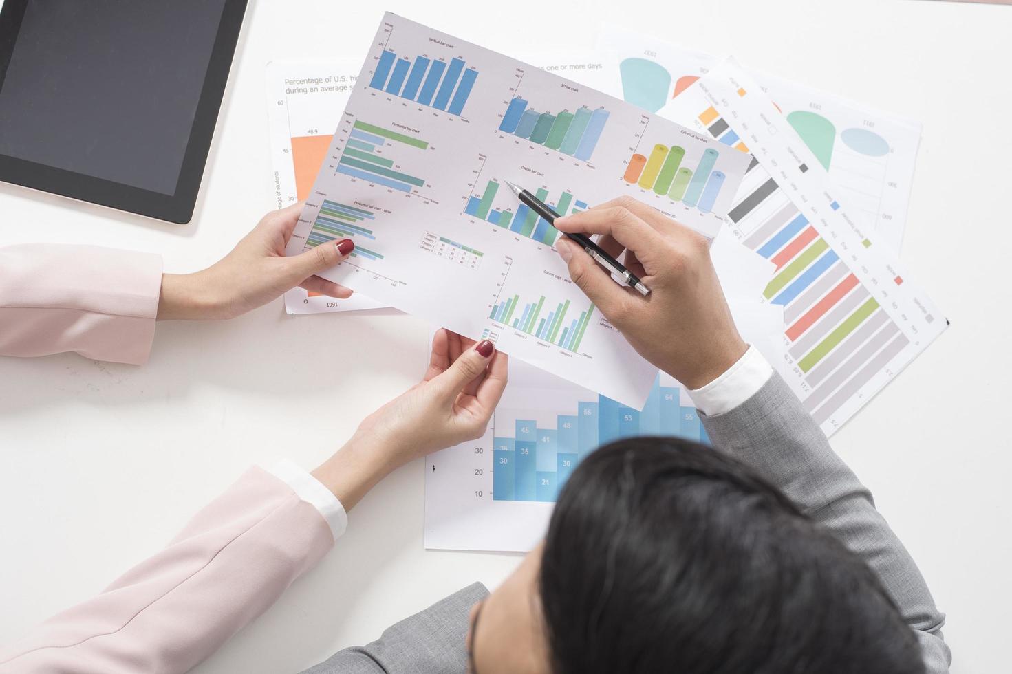 Businessman and businesswoman are analytic graph ,Business plan and business meeting concept photo