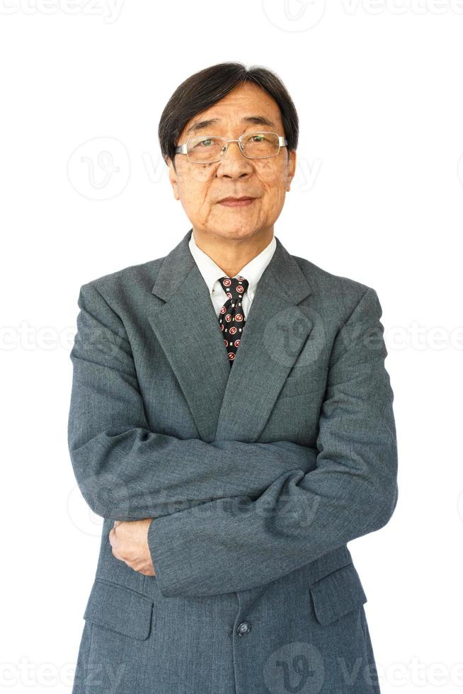 old aged thai businessman with glasses is standing and looking photo