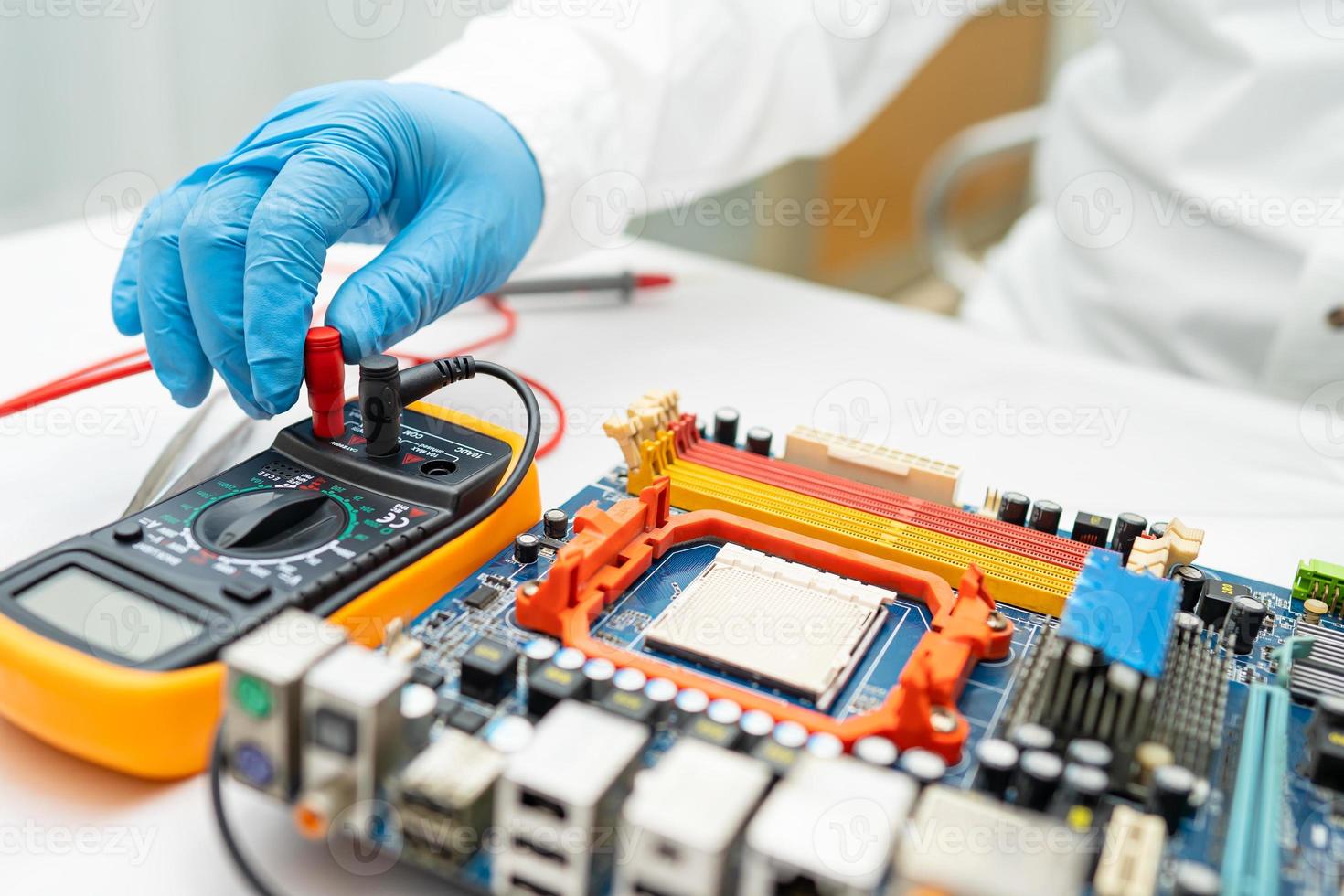 technician repairing inside of hard disk by soldering iron. Integrated Circuit. the concept of data, hardware, technician and technology. photo