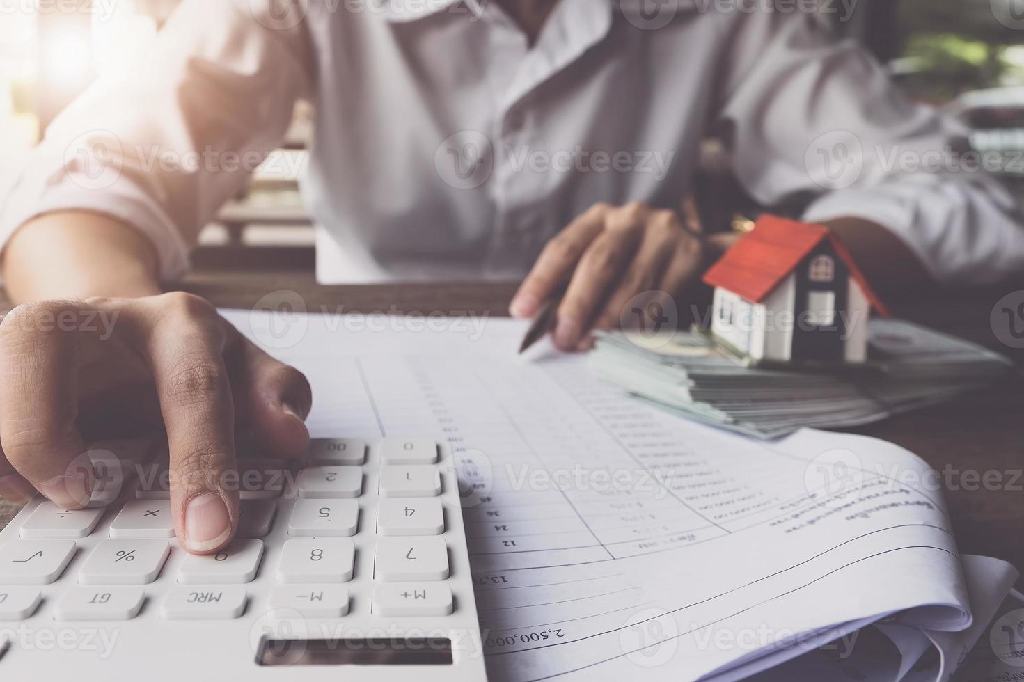 Customer uses pens and calculator to calculate home purchase loans photo