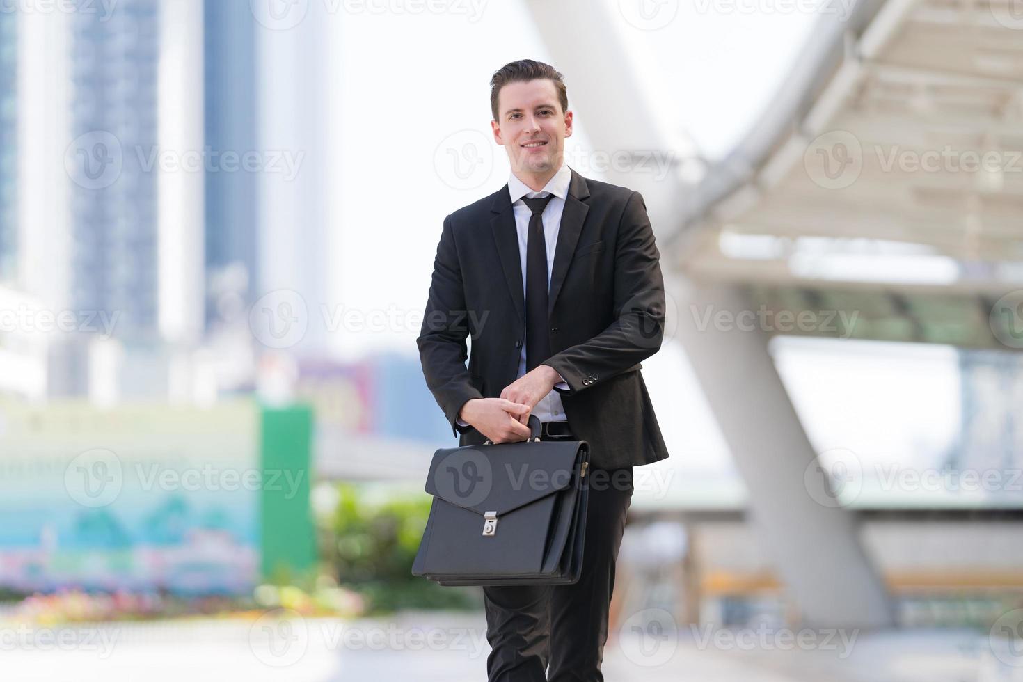 empresario exitoso en reunión de negocios sosteniendo maletín foto